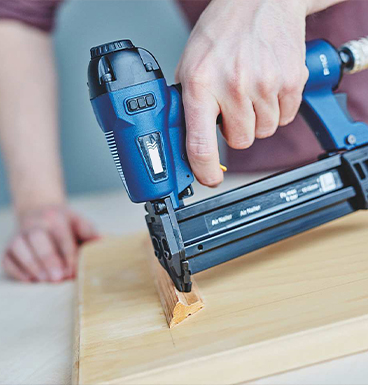 Penggunaan pistol paku pneumatik.